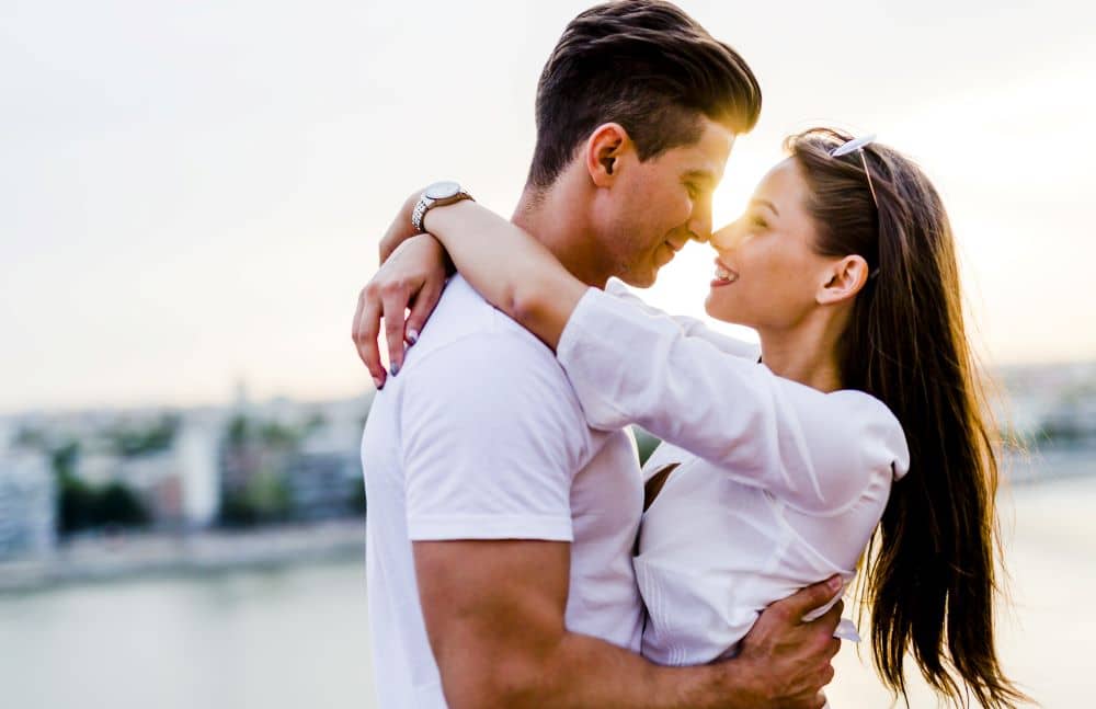 Young romantic couple hugging.