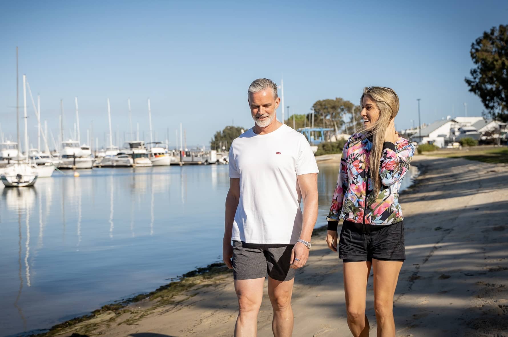 man and woman on a riverside walk