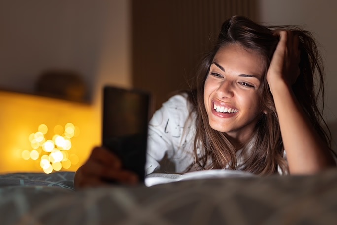 lady smiling at smartphone