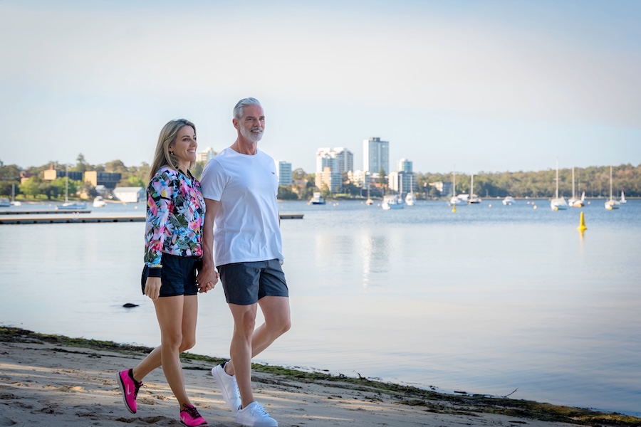 man and woman walking along perth foreshore