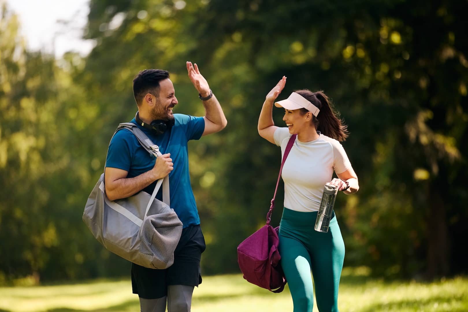 man and woman high-fiving playing golf