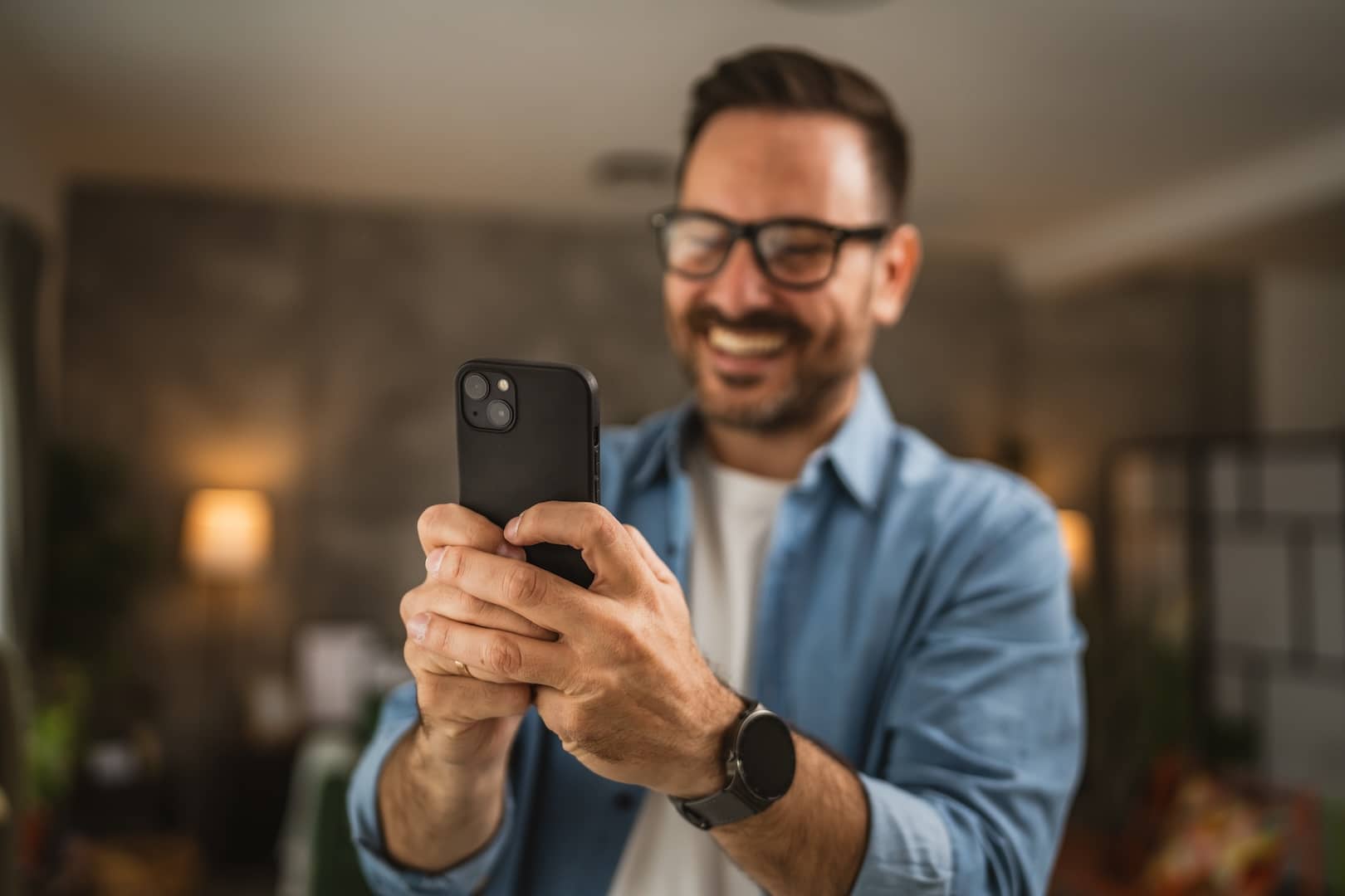 man smiling at his phone